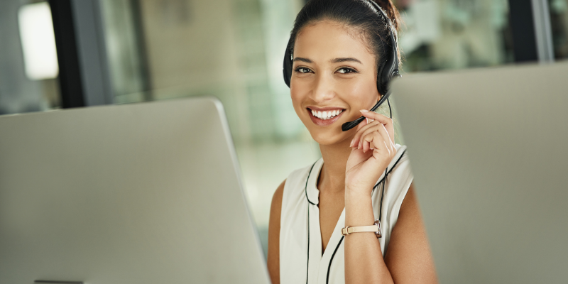 a woman sitting in front of a laptop computer