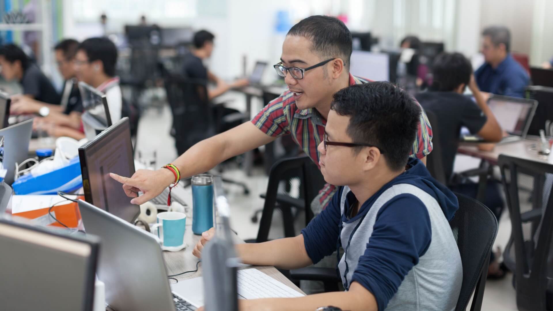 BPO employees looking at a computer