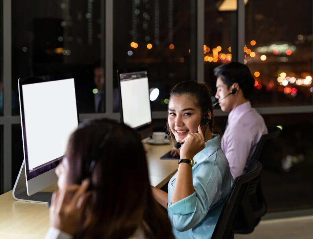 group of customer service representatives working at night