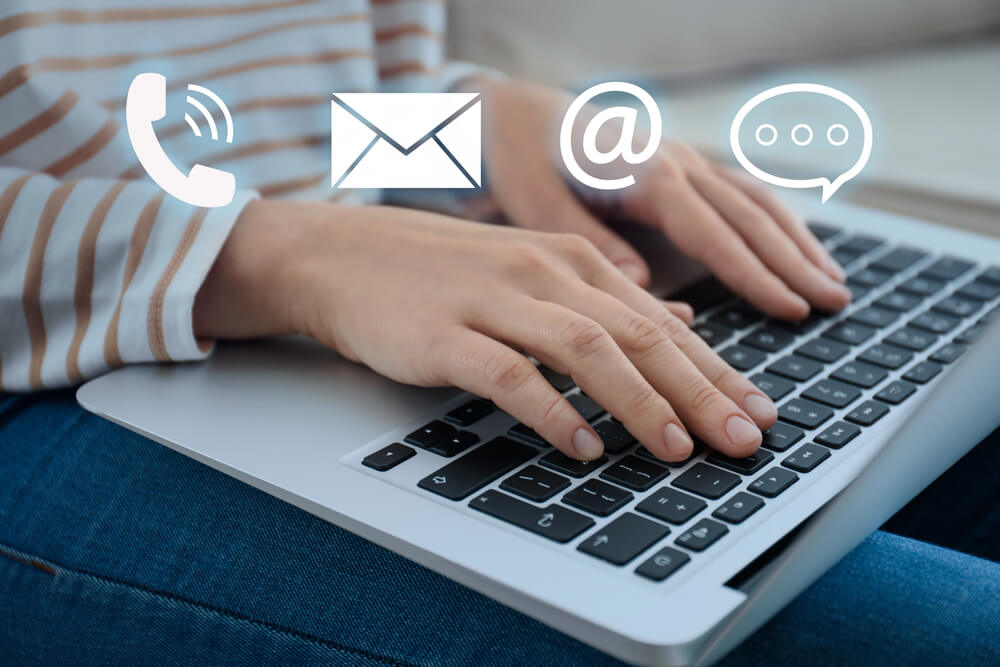 an email marketer typing on a laptop