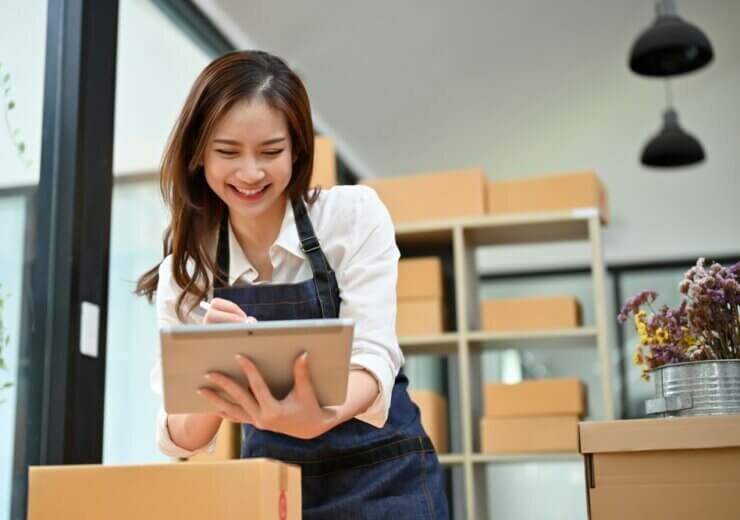 Attractive,Young,Asian,Female,E-commerce,Business,Owner,Using,Tablet,Touchpad